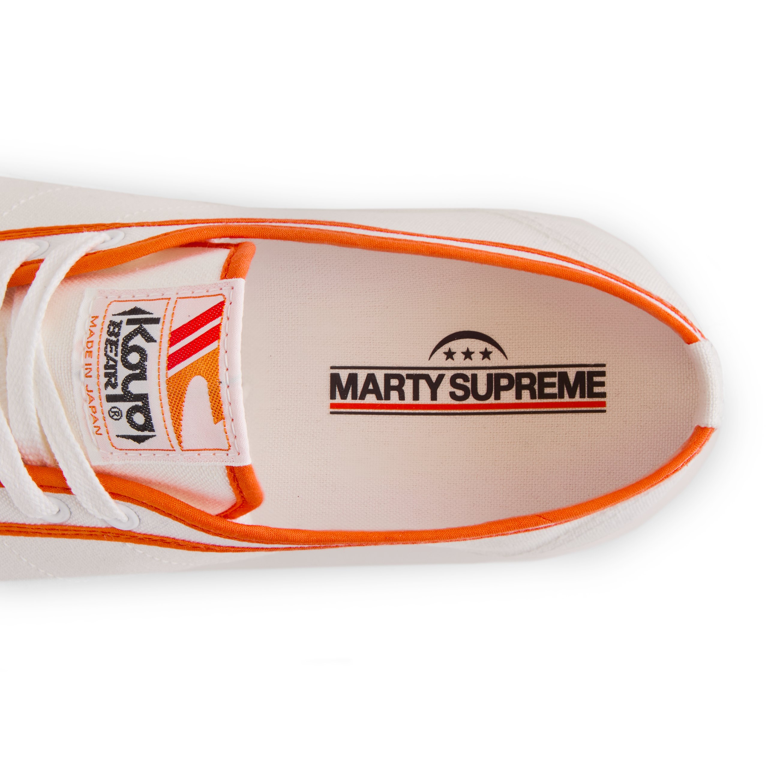Close-up of the insole print inside the orange white Koyo Bear Sharpman Marty Supreme sneakers with red and blue trim, showing the MARTY SUPREME logo.