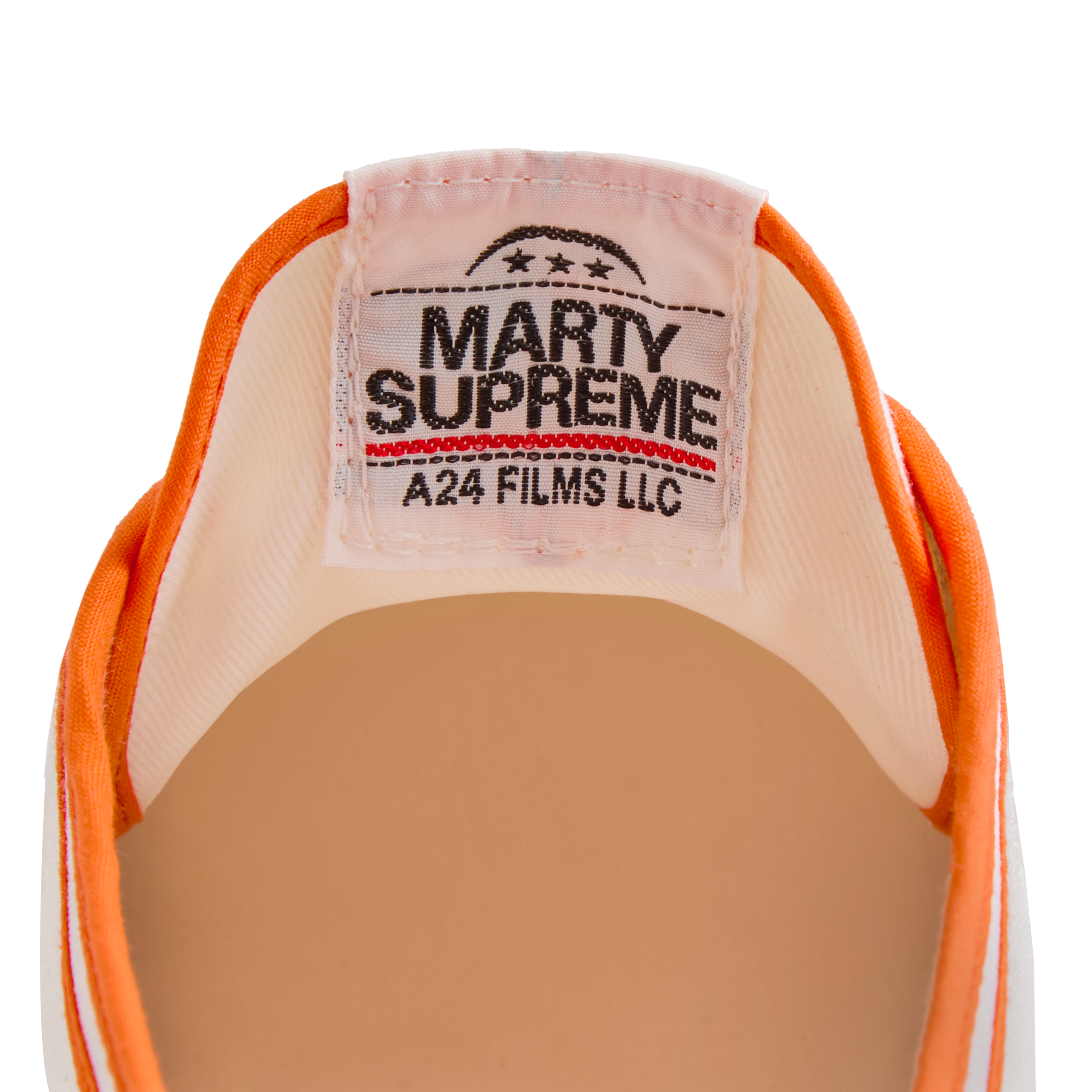 Close-up of the tongue label on the orange version Koyo Bear Sharpman Marty Supreme sneakers with red and blue trim, showing the A24 Films LLC logo and Made in Japan branding.
