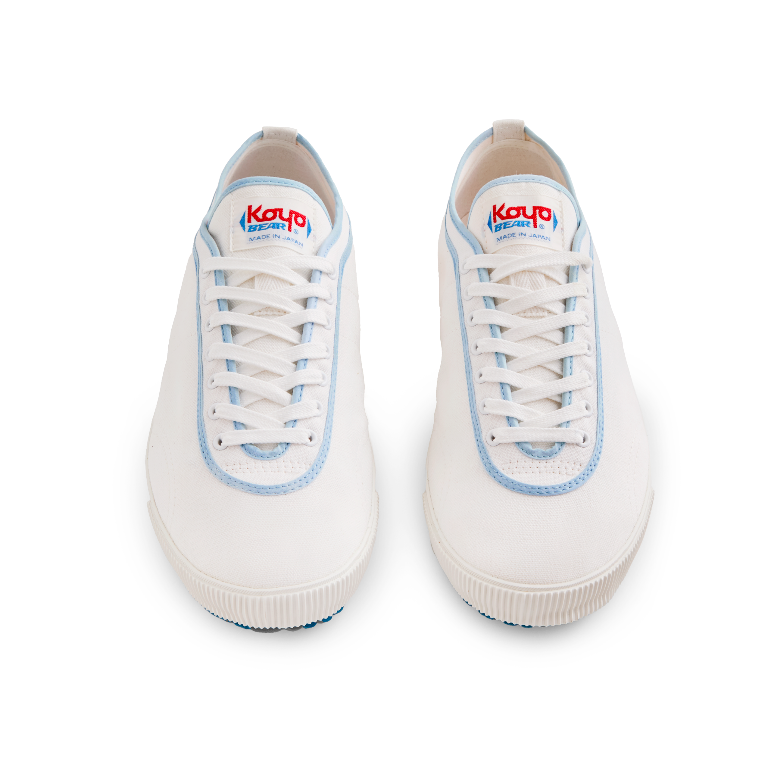 Front view of the handmade Koyo Bear Sharpman Blue Trim canvas sneakers, made in Japan in white canvas with light blue piping, shown as a matching pair with the classic low-profile table tennis design.