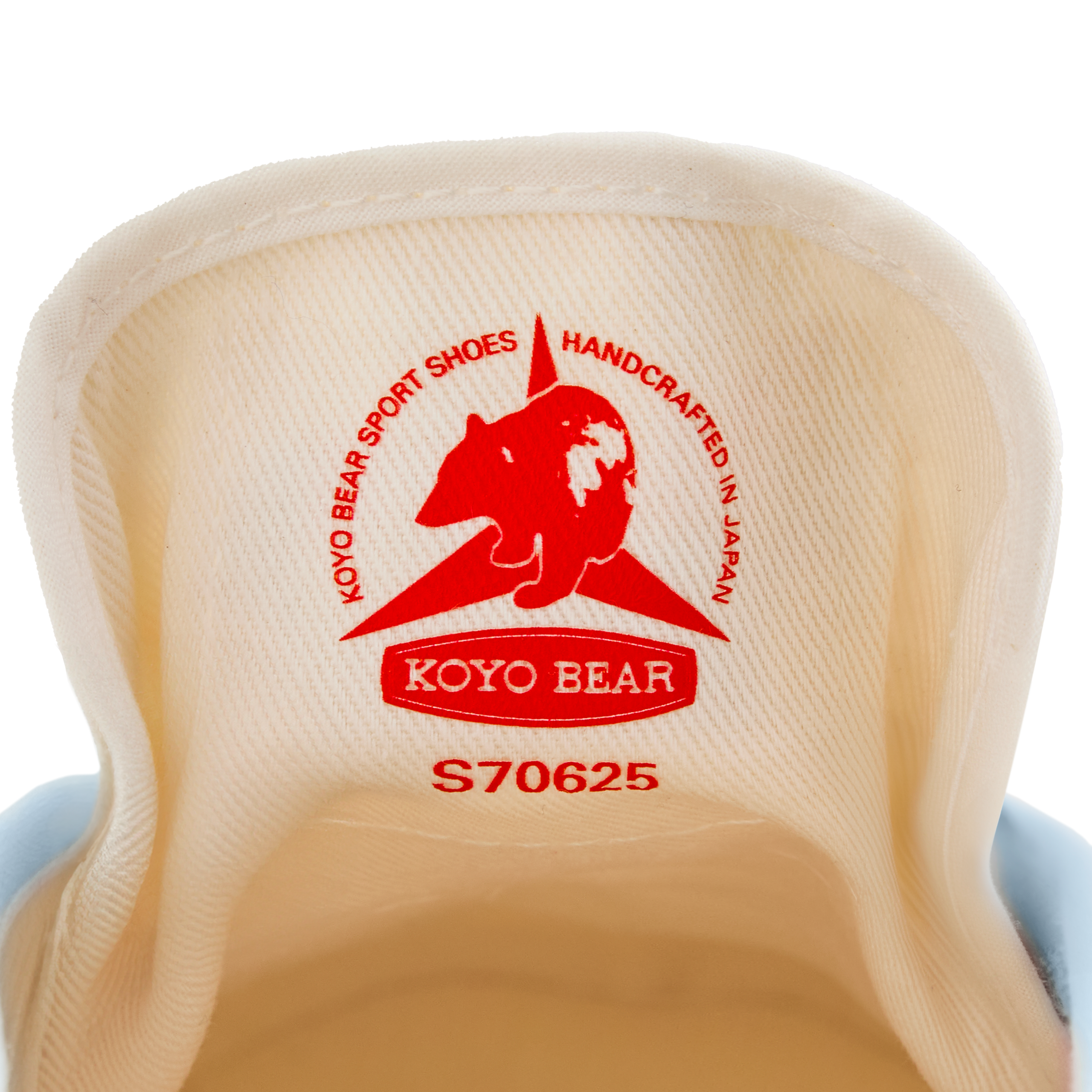 Close-up of the inner tongue label on the handmade Koyo Bear Sharpman Blue Trim canvas sneakers, made in Japan, showing the Koyo Bear logo and “Handcrafted in Japan” stamp from the world’s first purpose-built table tennis shoe.