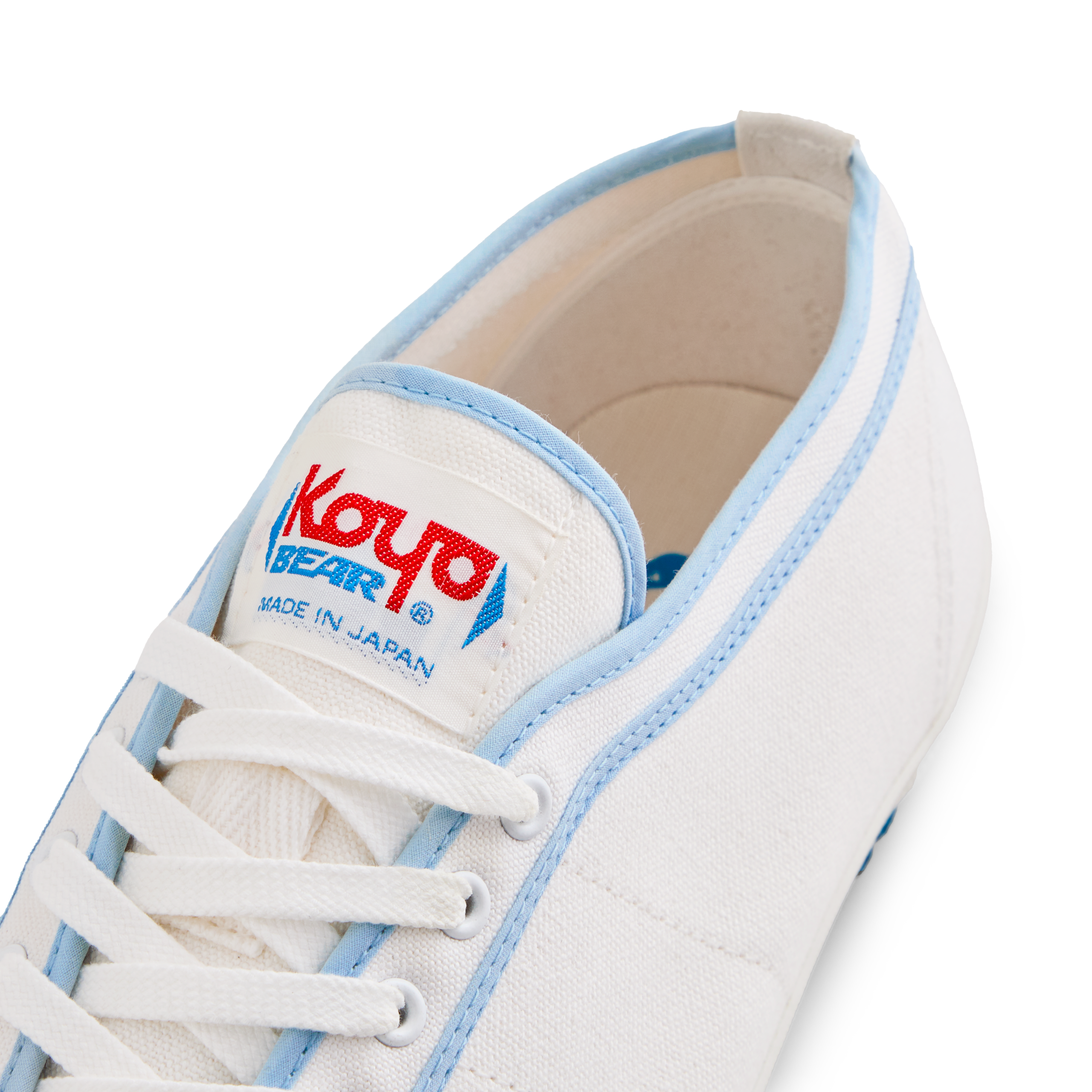 Close-up of the tongue label on the handmade Koyo Bear Sharpman Blue Trim canvas sneakers, made in Japan, showing the Koyo Bear logo on the world’s first purpose-built table tennis shoe.