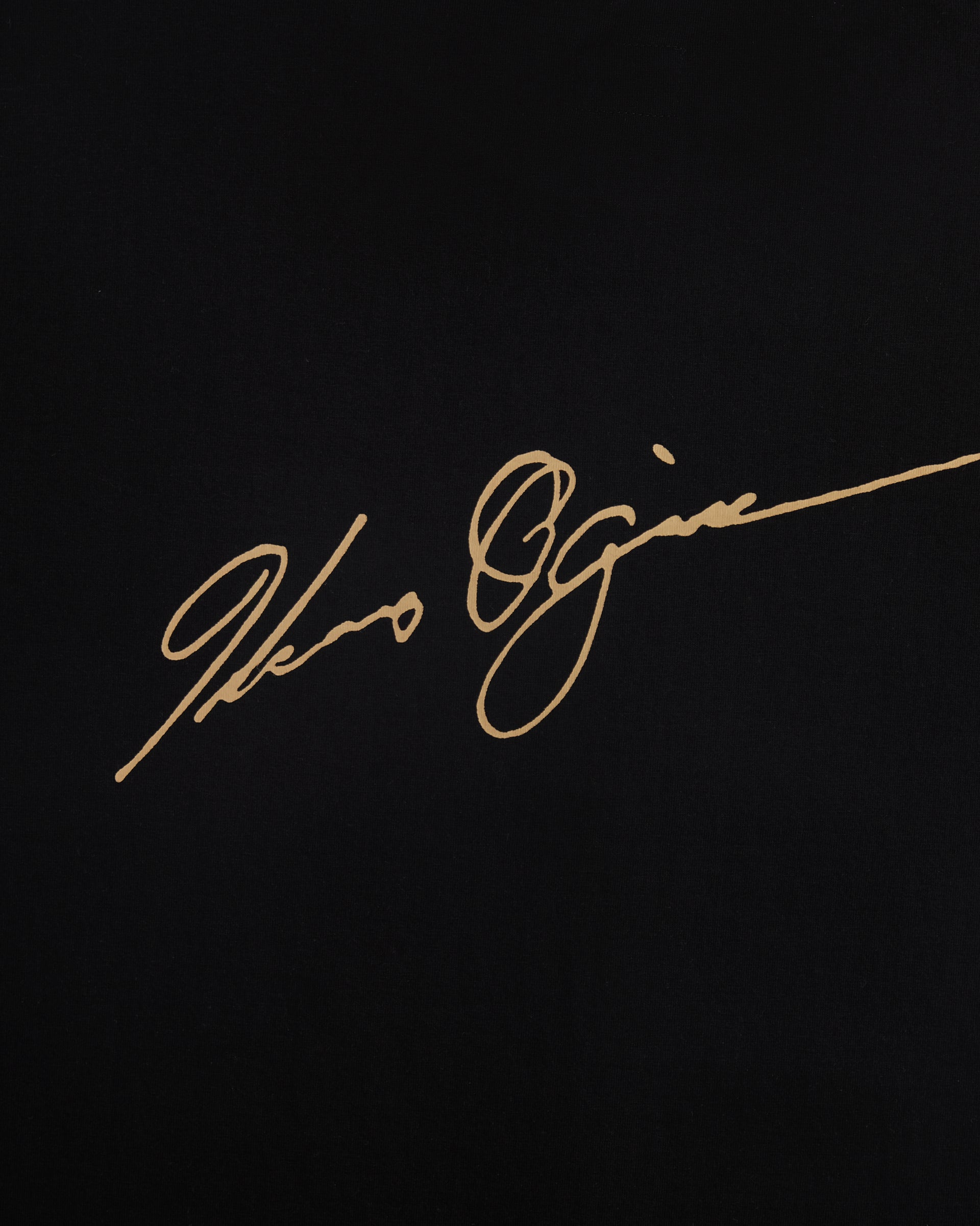 Close-up of the gold Ichiro Ogimura signature printed on the back of the Koyo Bear OGI Signature Return T-shirt.