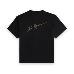 Back view of the black Koyo Bear Ichiro Ogimura OGI Signature Return T-shirt featuring the gold Ogimura signature print.