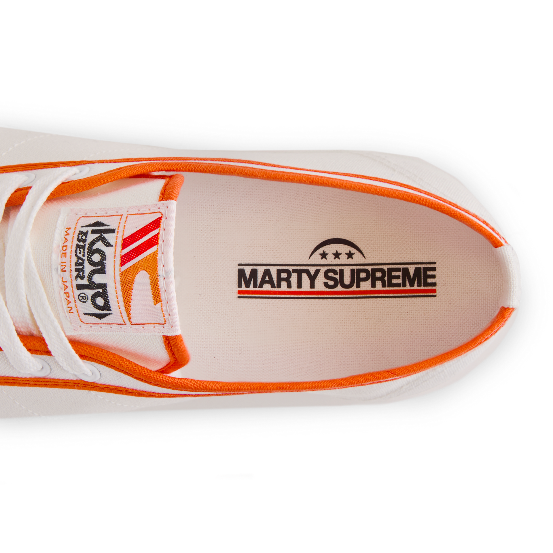 Close-up of the insole print inside the orange white Koyo Bear Sharpman Marty Supreme sneakers with red and blue trim, showing the MARTY SUPREME logo. 