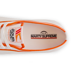 Close-up of the insole print inside the orange white Koyo Bear Sharpman Marty Supreme sneakers with red and blue trim, showing the MARTY SUPREME logo. 
