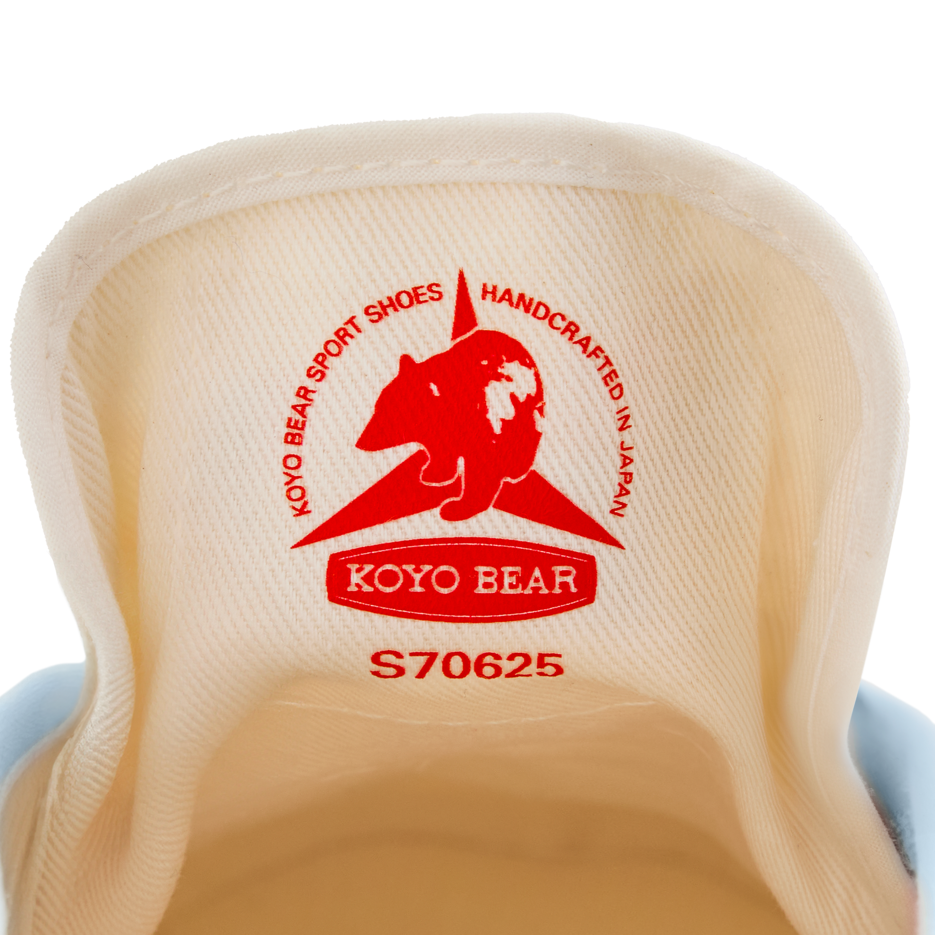 Close-up of the inner tongue label on the handmade Koyo Bear Sharpman Blue Trim canvas sneakers, made in Japan, showing the Koyo Bear logo and “Handcrafted in Japan” stamp from the world’s first purpose-built table tennis shoe.