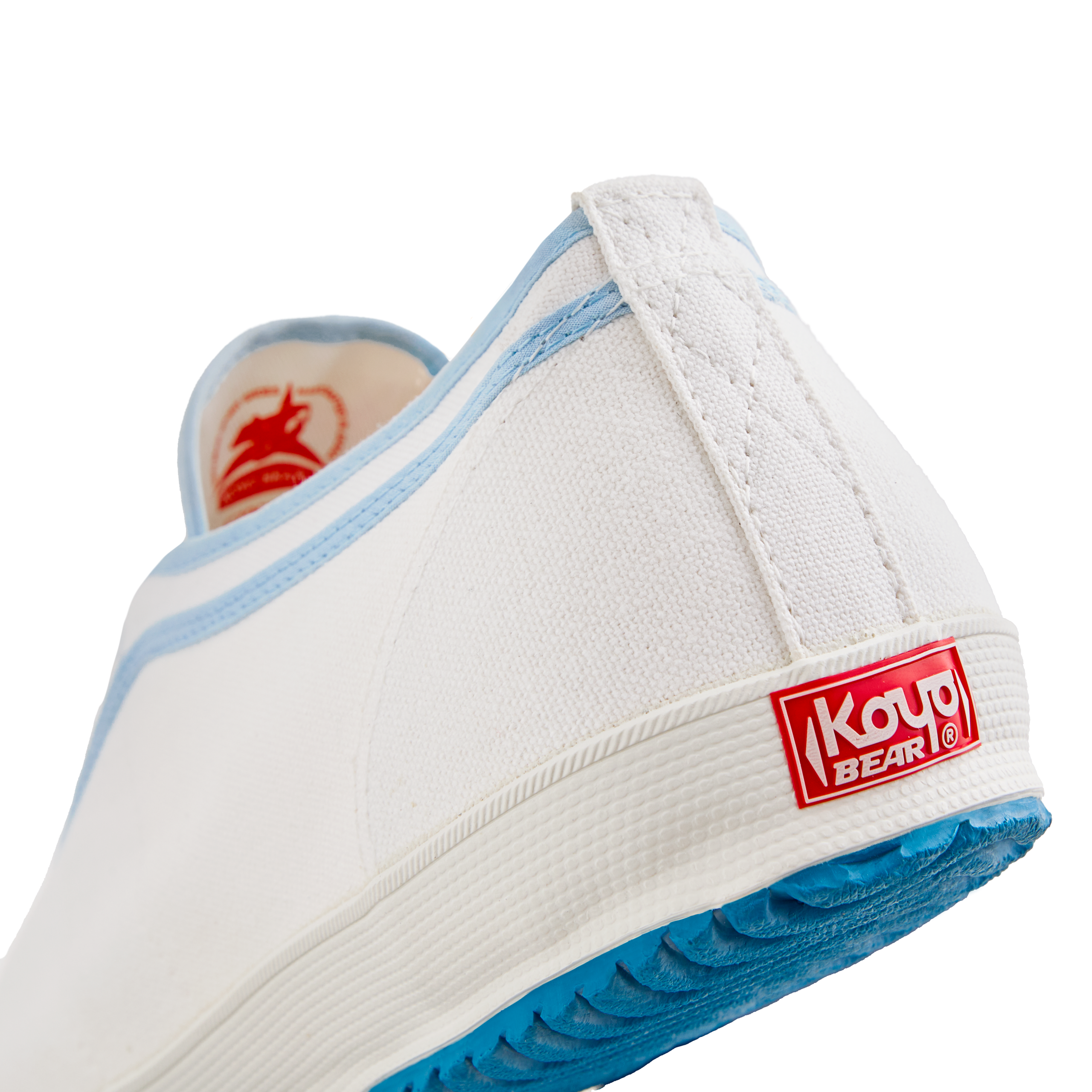 Back view of the handmade Koyo Bear Sharpman Blue Trim canvas sneakers, made in Japan in white canvas with light blue piping, showing the Koyo Bear heel logo and blue vulcanised rubber sole.