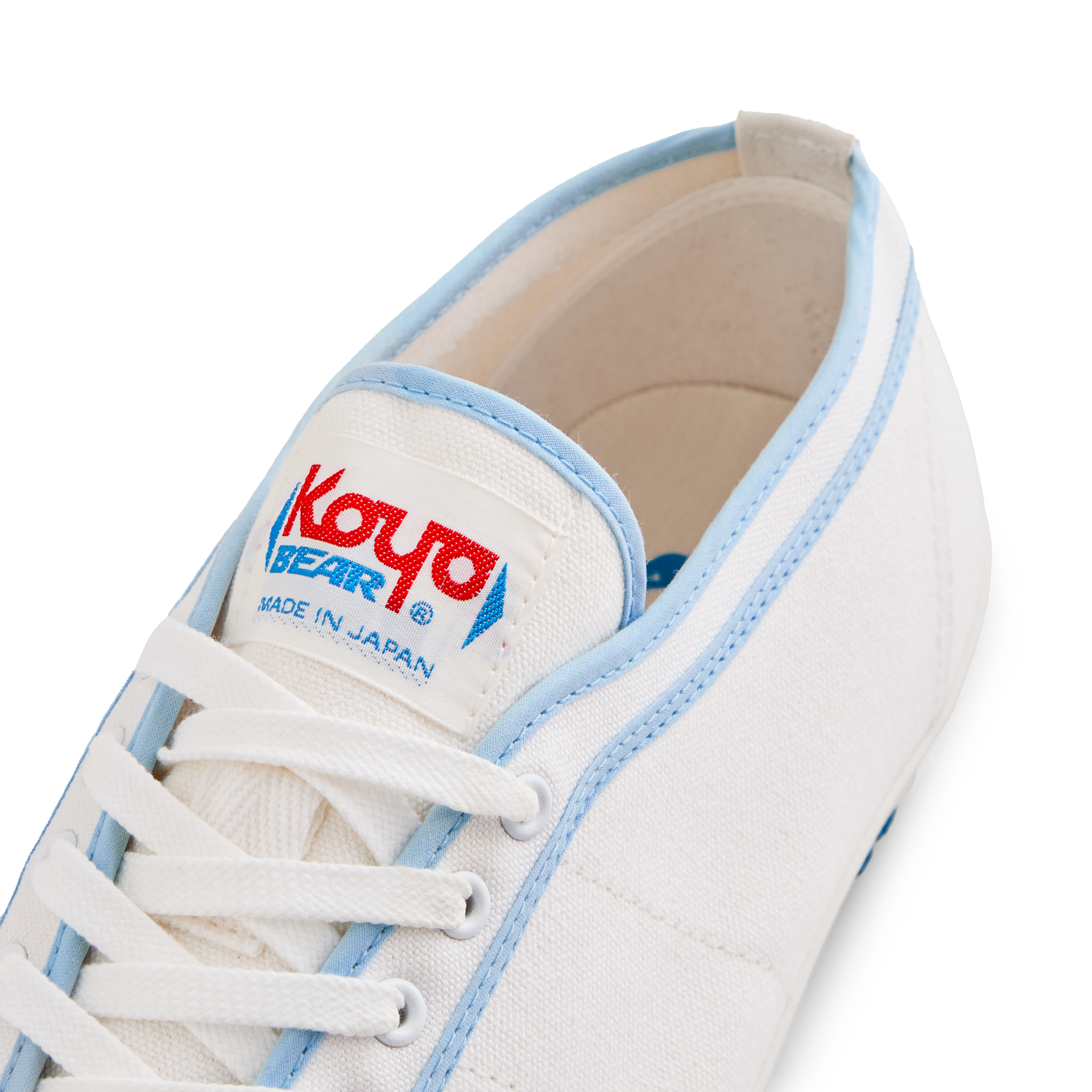 Close-up of the tongue label on the handmade Koyo Bear Sharpman Blue Trim canvas sneakers, made in Japan, showing the Koyo Bear logo on the world’s first purpose-built table tennis shoe.