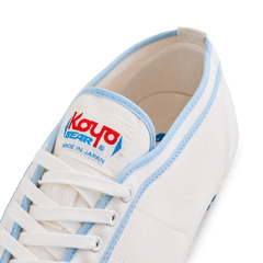 Close-up of the tongue label on the handmade Koyo Bear Sharpman Blue Trim canvas sneakers, made in Japan, showing the Koyo Bear logo on the world’s first purpose-built table tennis shoe.