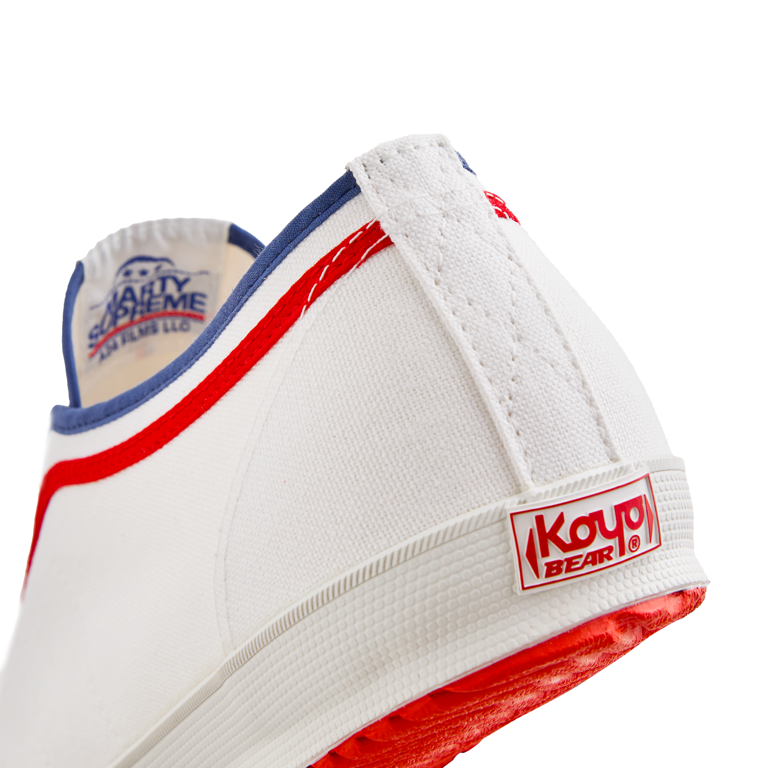 Side back view of the white Koyo Bear Sharpman Marty Supreme sneakers with red and blue trim, showing the heel patch and rear logo.