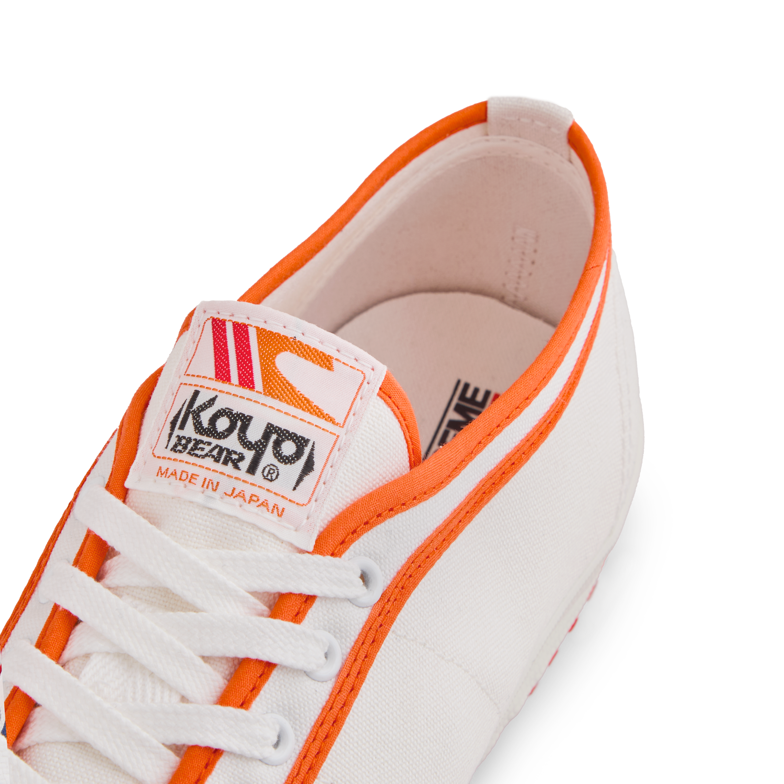 Tongue label of the orange white Koyo Bear Sharpman Marty Supreme sneakers with red and blue trim, showing the logo and Made in Japan branding.