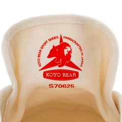Close-up of the inner tongue label on the handmade Koyo Bear Sharpman White Trim canvas sneakers, made in Japan, showing the Koyo Bear logo and “Handcrafted in Japan” stamp of the original table tennis shoe.