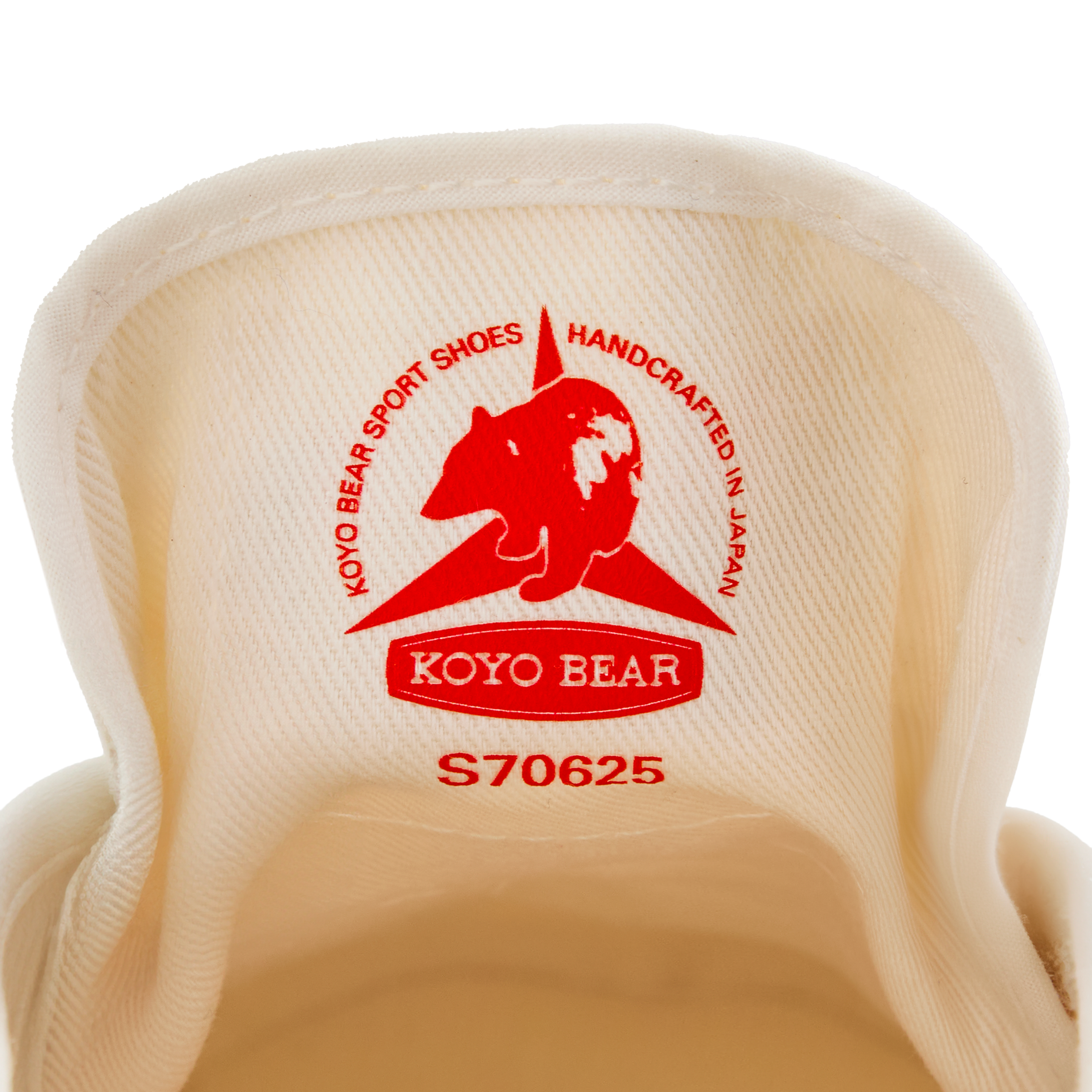 Close-up of the inner tongue label on the handmade Koyo Bear Sharpman White Trim canvas sneakers, made in Japan, showing the Koyo Bear logo and “Handcrafted in Japan” stamp of the original table tennis shoe.