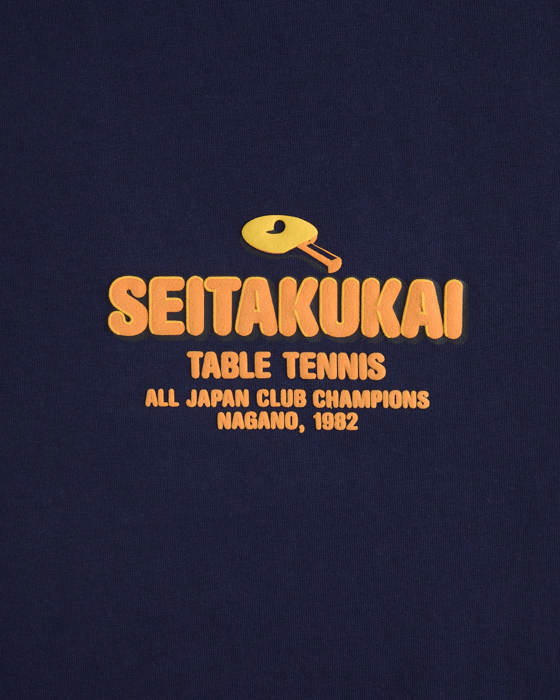 Front print of the Koyo Bear Team SEITAKUKAI design featuring the yellow table tennis club logo from the 1982 Nagano champions.