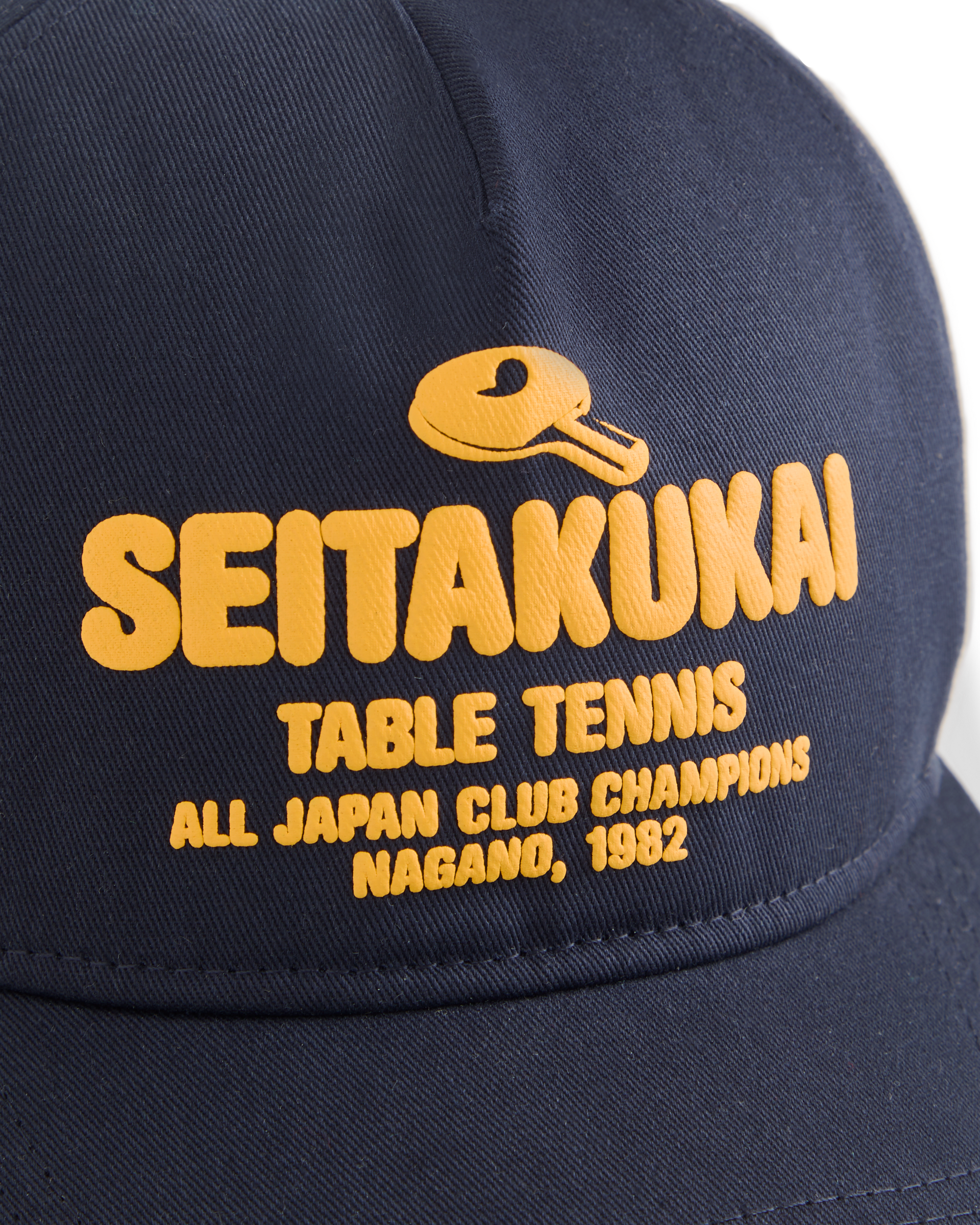 Navy Koyo Bear Seitakukai table tennis cap with yellow embroidered logo, celebrating the 1982 All-Japan Club Champions in Nagano close up