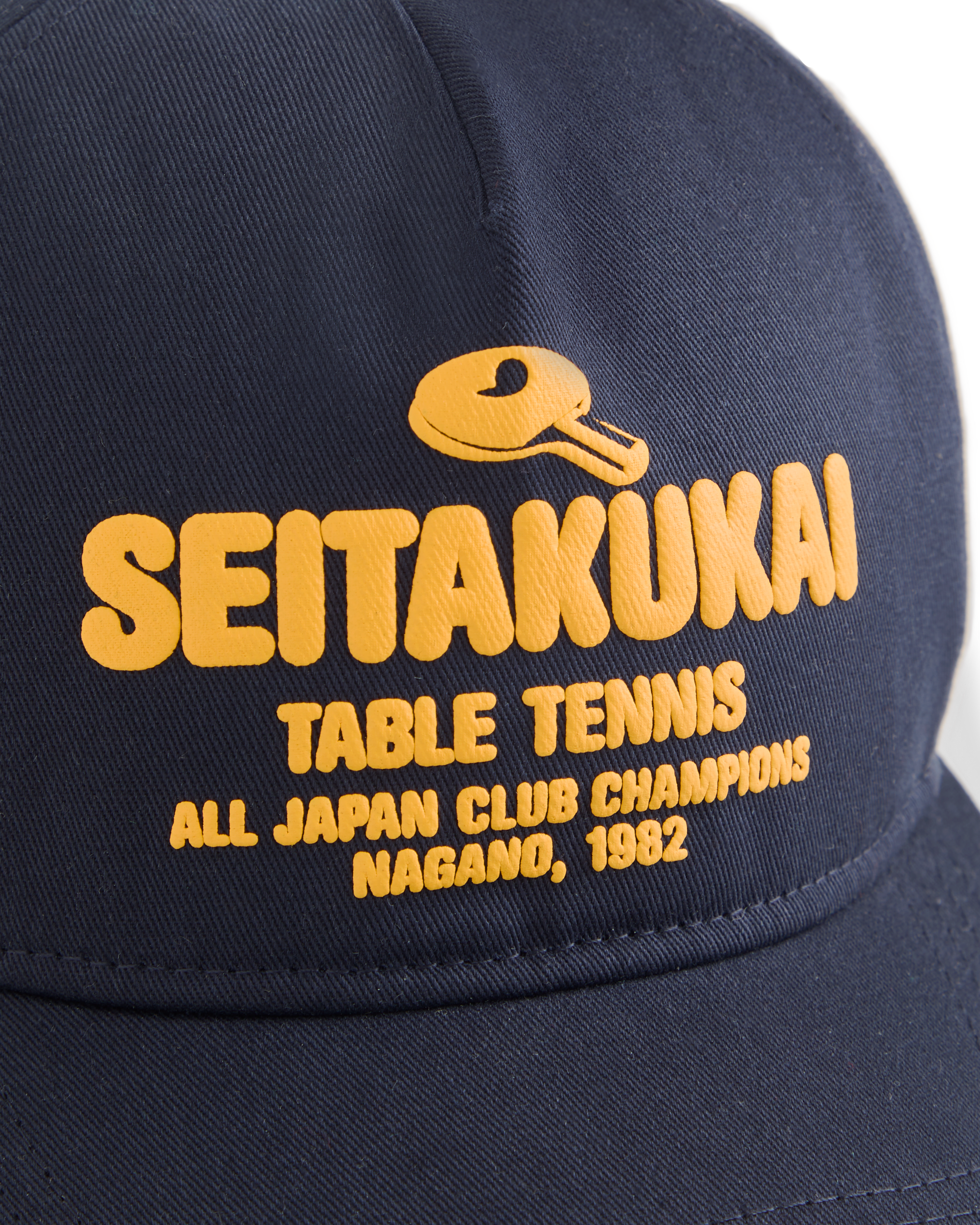 Navy Koyo Bear Seitakukai table tennis cap with yellow embroidered logo, celebrating the 1982 All-Japan Club Champions in Nagano close up