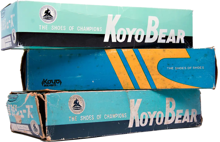 Stack of vintage Koyo Bear shoeboxes from Japan, showing the historic “The Shoes of Champions” branding used for the brand’s performance sneakers.