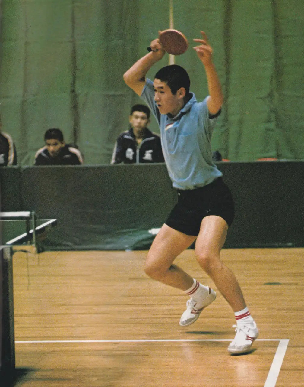 Table tennis player in action wearing Koyo Bear Sharpman Nimble shoes, the purpose-built table tennis sneakers designed for agile footwork and fast directional changes.